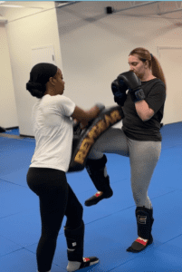Laura and Ce'Dirra doing some knee drills in Muay thai kickboxing